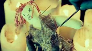 Image of 'voodoo doll' and painted black hands in Florence + the Machine video. Via Jezebel